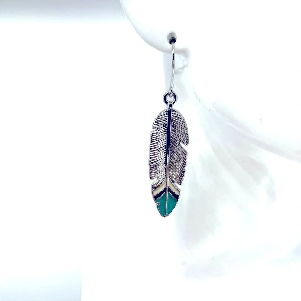 Boho Festival silver tone feather earrings with turquoise blue tips